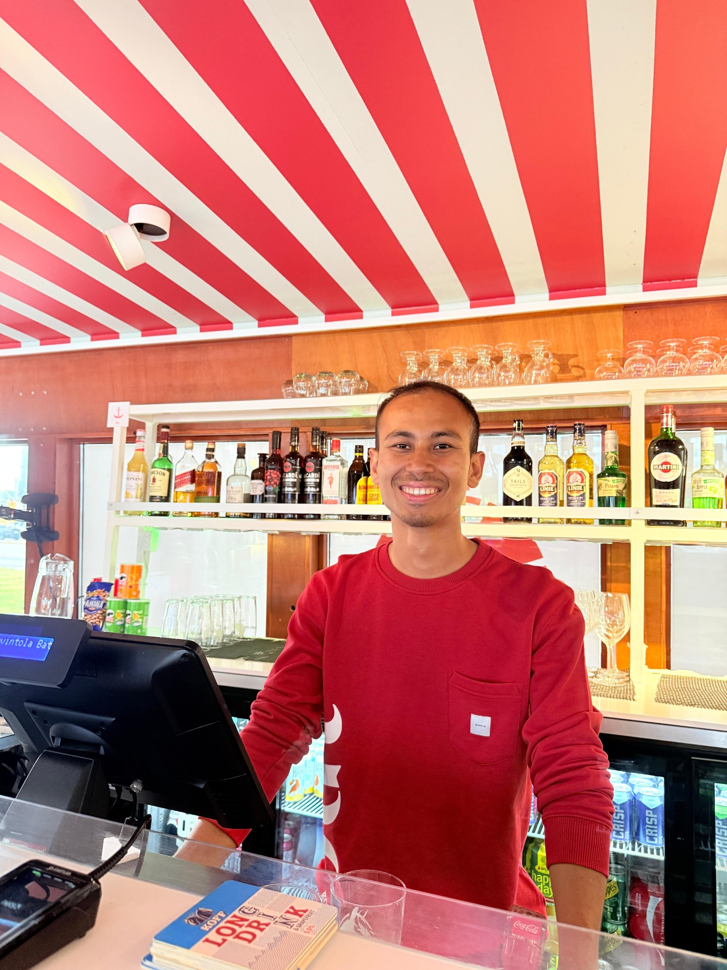 Ujjwal Shrestha supporting hospitality service behind a bar counter